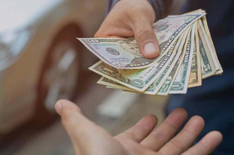 person handing over cash