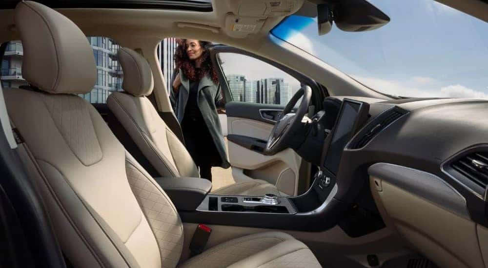 A person is shown opening the door of a 2024 Ford Edge.