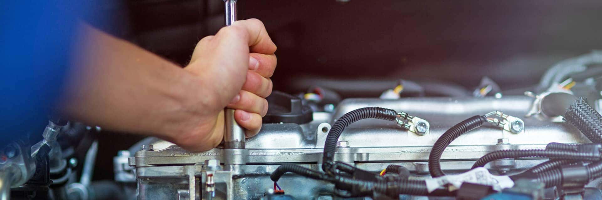 Zoomed in shot of mechanic working on engine