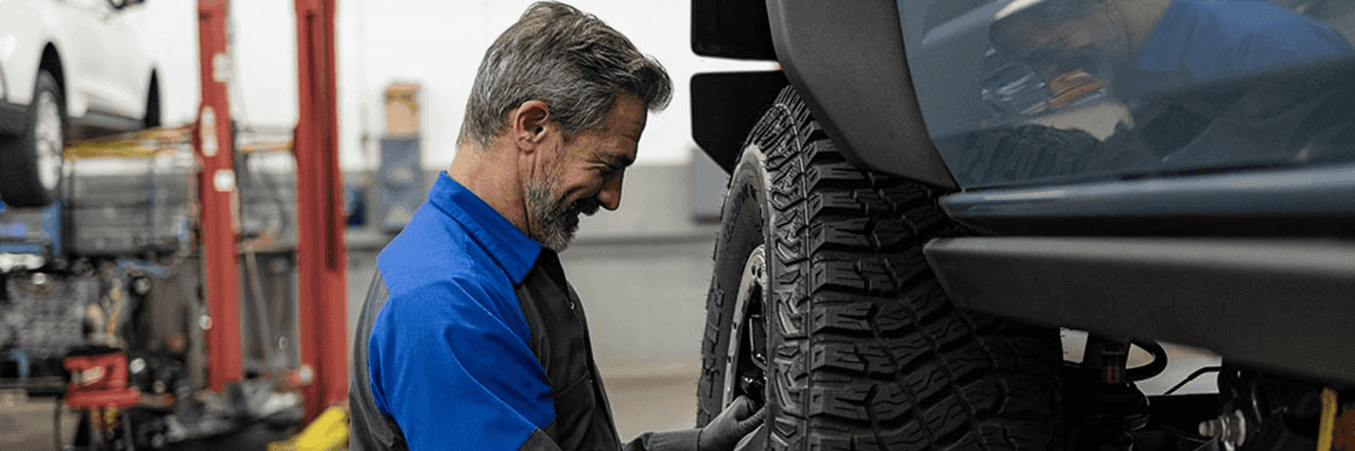 ford service tech working on tire