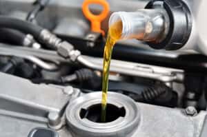 Oil being poured into a vehicle