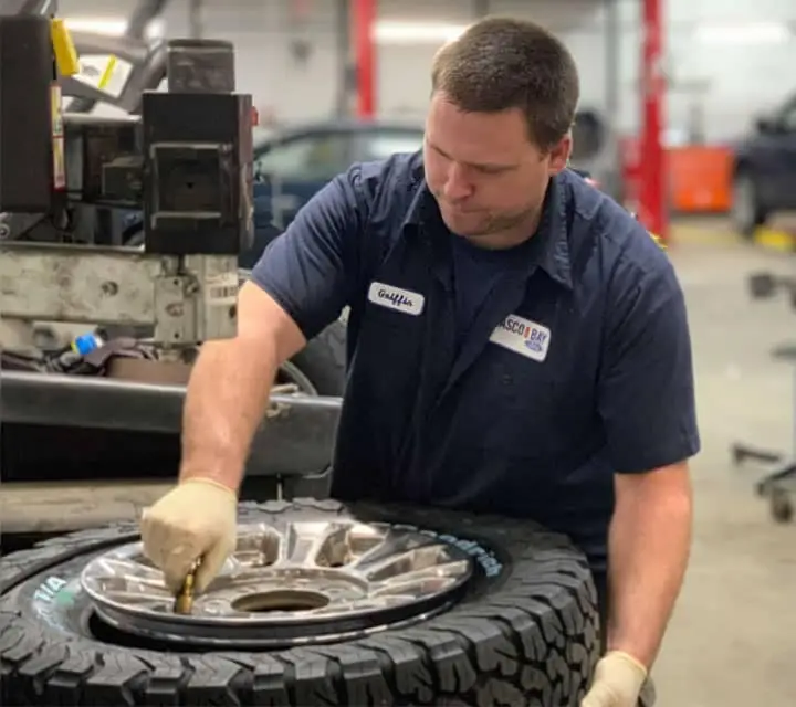 Mechanic holding a tool in the Ford Service Center