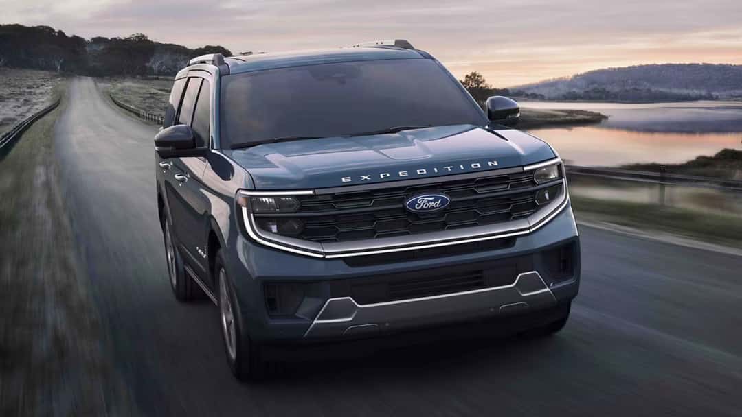 2025 ford expedition driving on a road near water