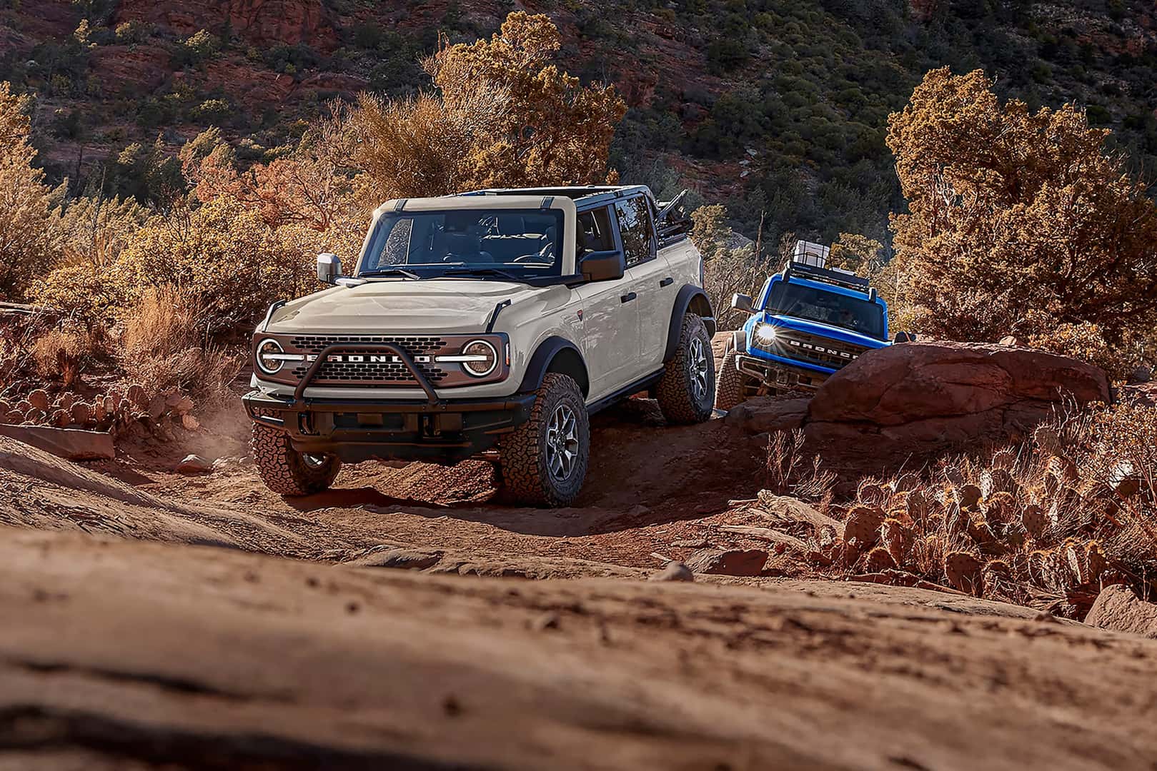 Two 2026 Ford Bronco's driving in the mountains
