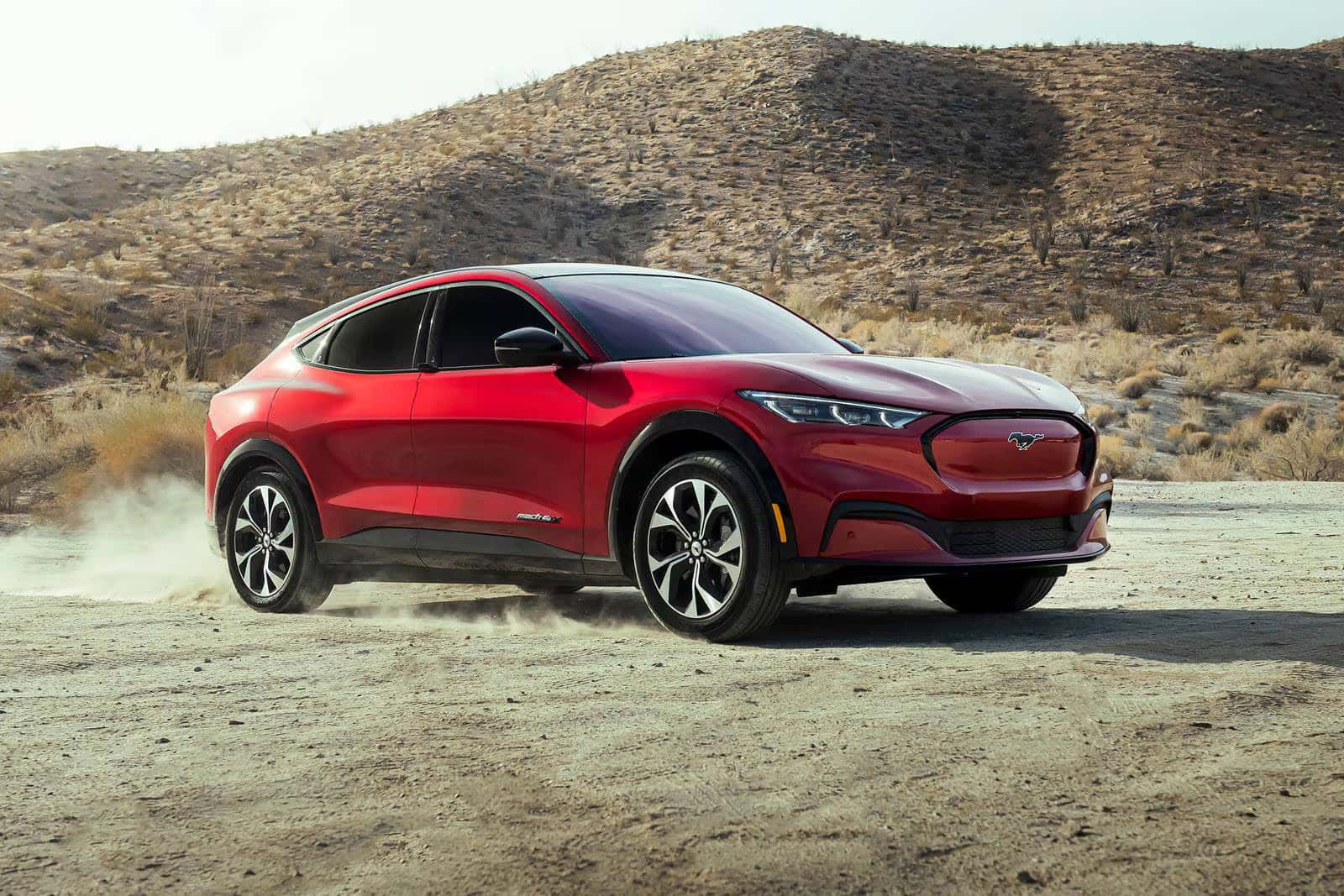 red exterior view of a 2026 ford mustang mach e with a desert background