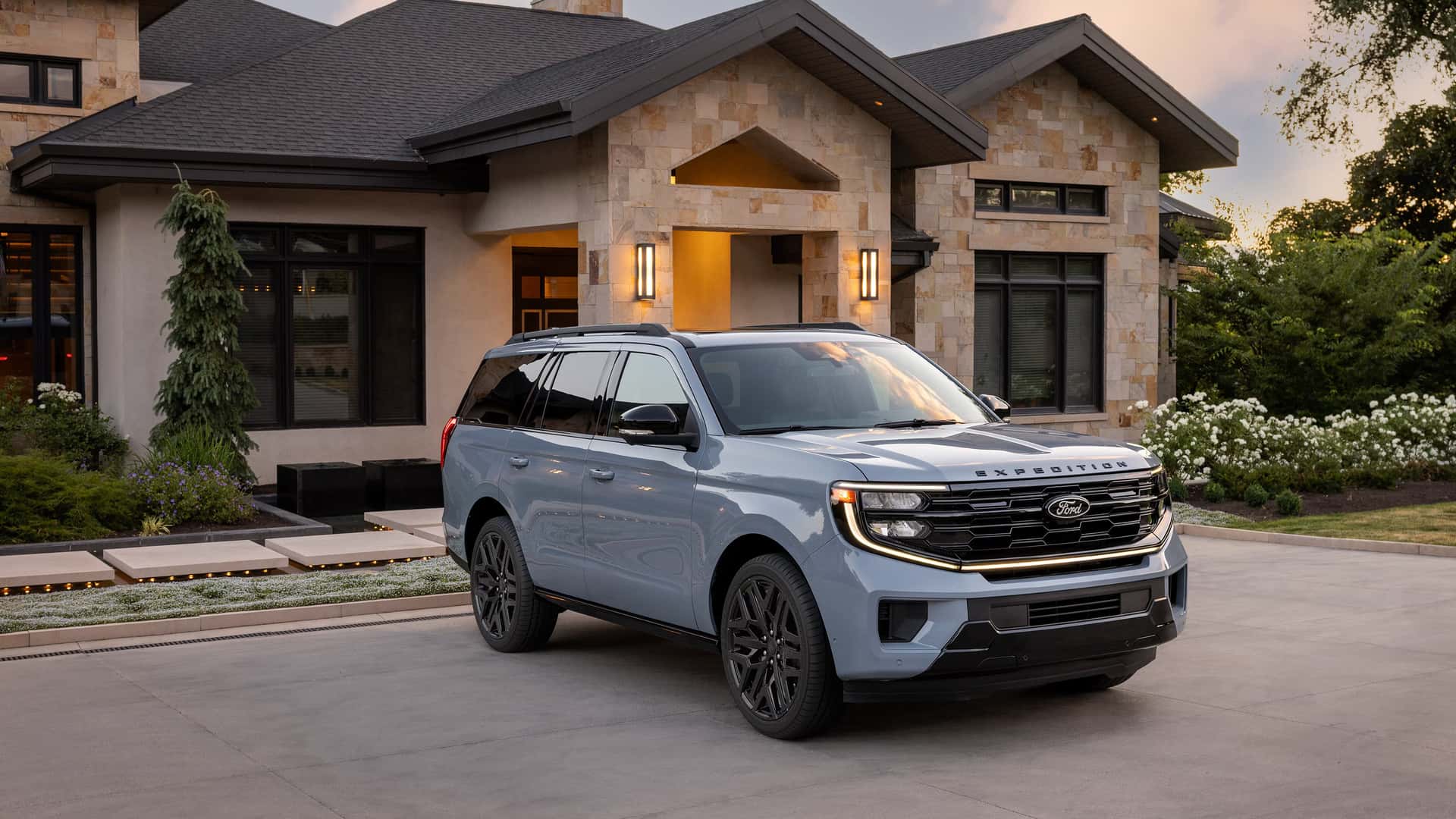 a blue 2026 ford expedition parked at a home