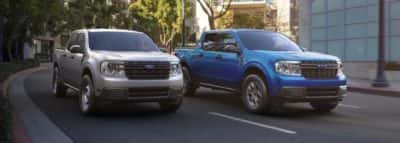 Two ford trucks racing down the street.