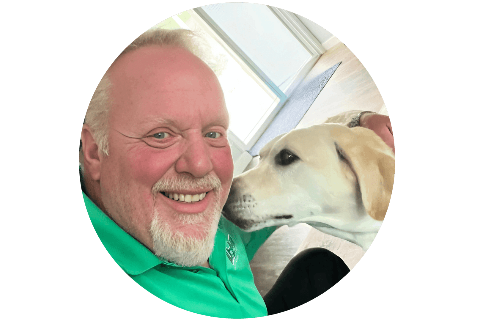 Scott Webb smiling while his yellow lab boops his face
