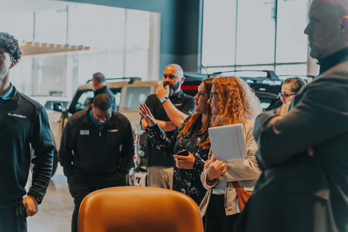 Shaking hands with a dealership sales representative for the purchase of a vehicle