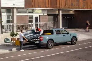 People loading the bed of a Ford Maverick
