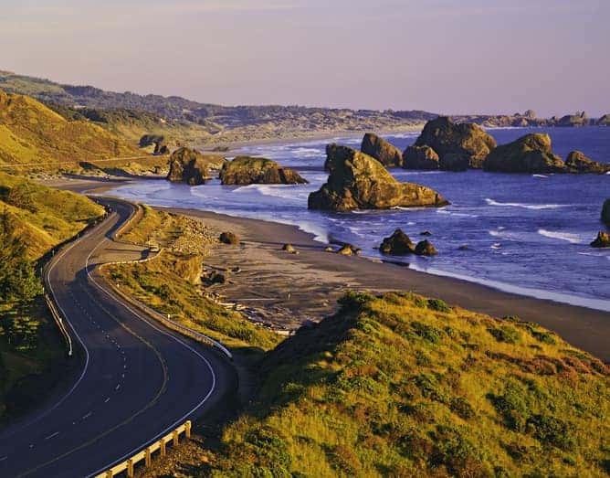 Scenic coast of Oregon at Cape Sebastian with massive rocks and sandy beach.