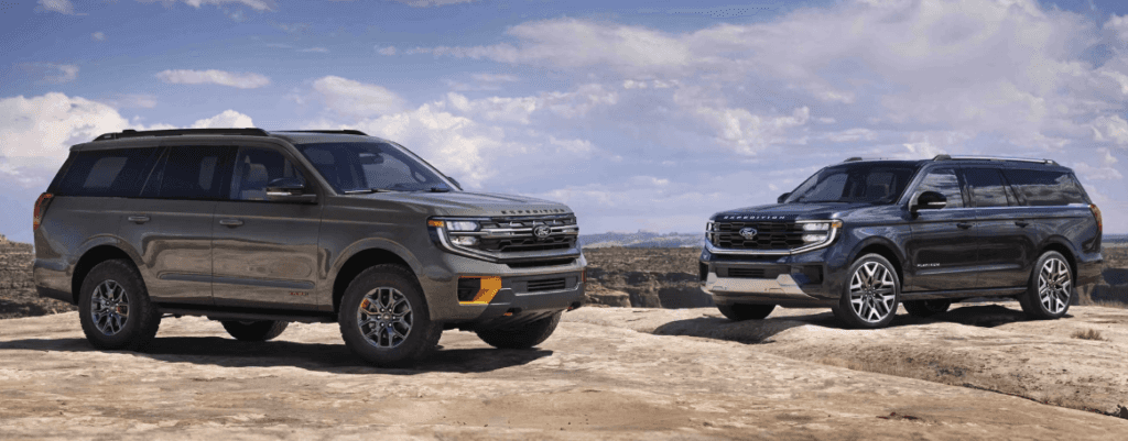 Two 2025 Ford Expedition SUVs are parked on a rocky plateau under a partly cloudy sky. The vehicle on the left is a rugged off-road trim in matte green with orange accent trim, while the one on the right is a sleek, upscale trim in metallic blue, showcasing a more refined design. Both models are positioned to highlight their size, styling, and versatility.