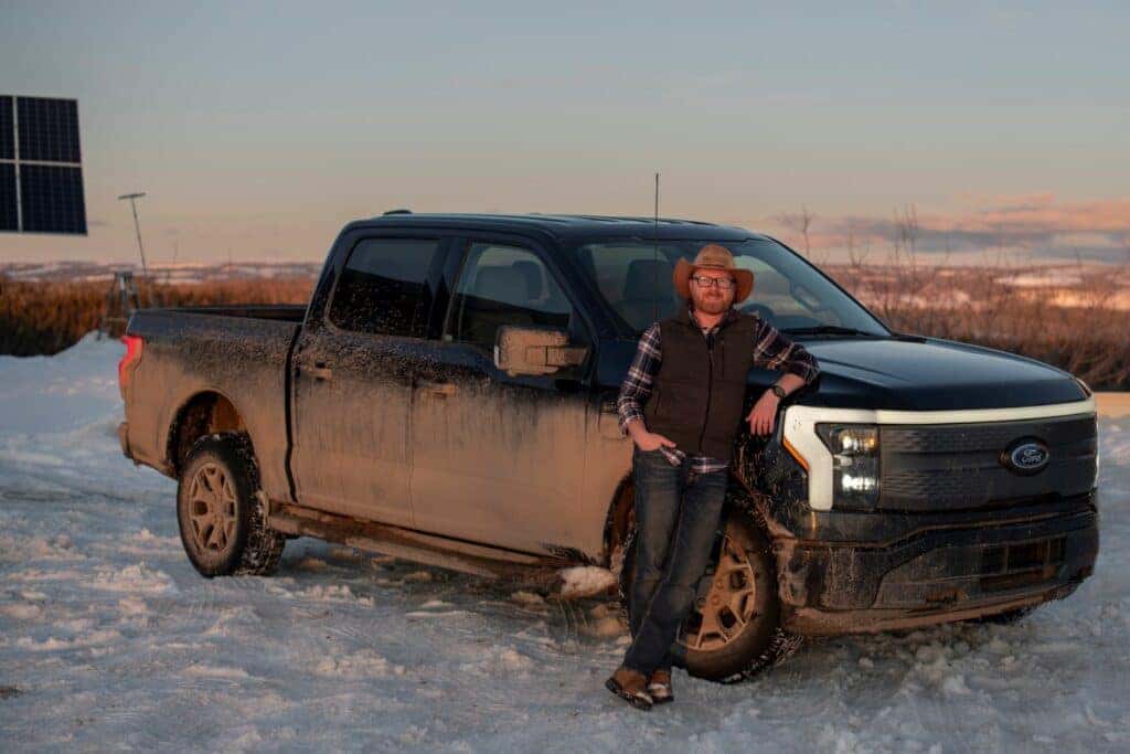 Smiling Ben Westsby Leaning On His Powerful Ford F-150 Lightning