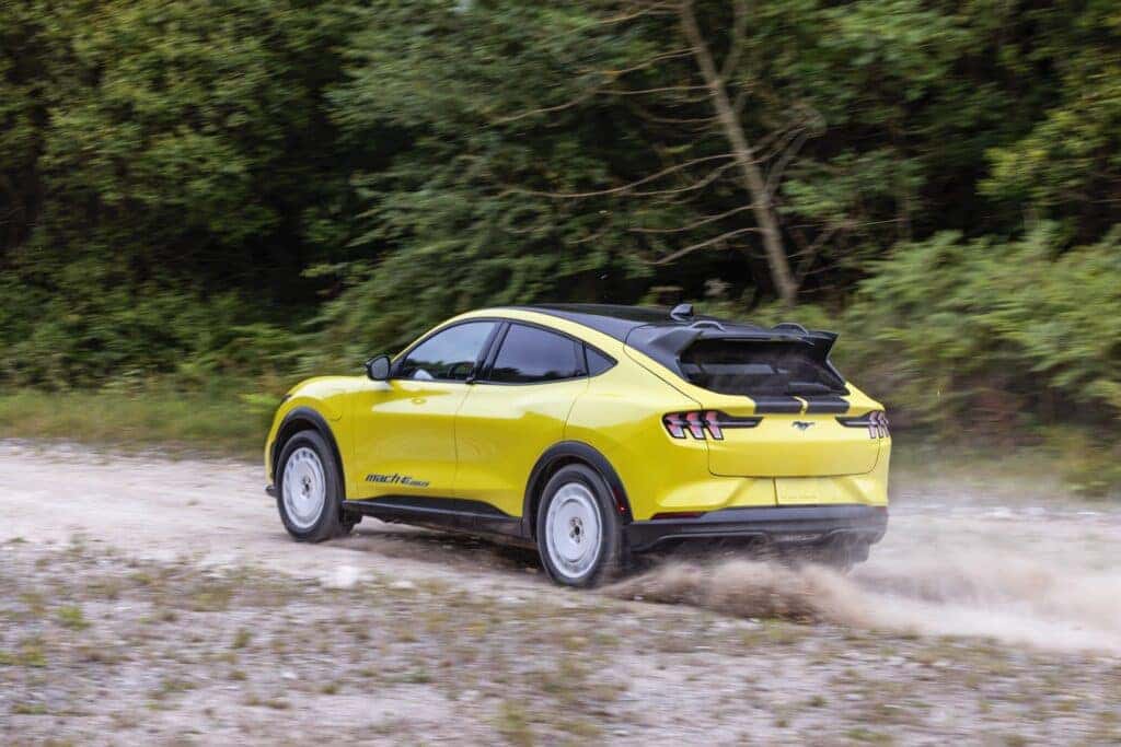 Back View Of The All-Electric Mustang Mach E Rally Speeding Off-Road