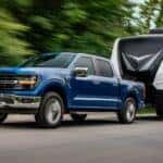 An Azure 2024 Ford F-150 Pulling A Trailer