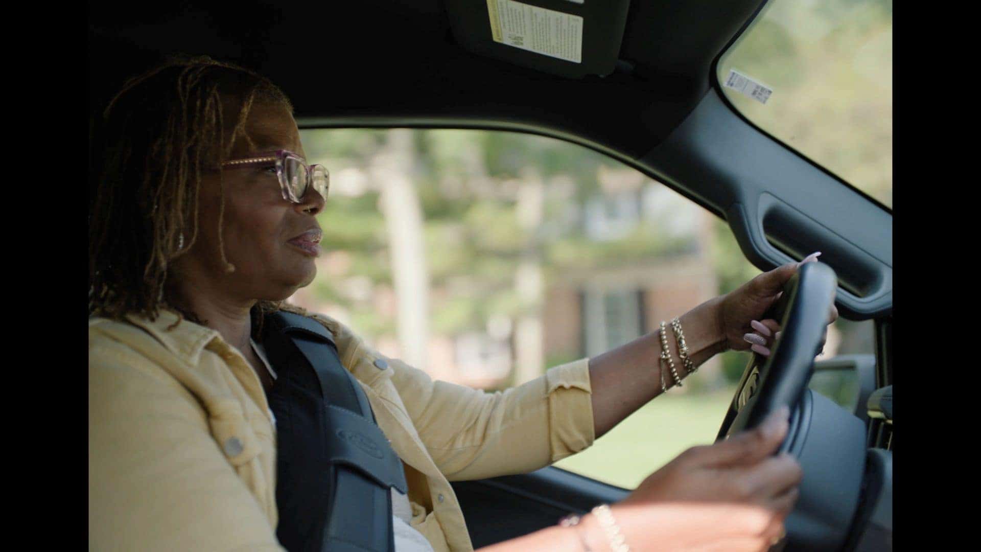 A Breast Cancer Warrior Wearing A SupportBelt While Driving Her Ford Vehicle