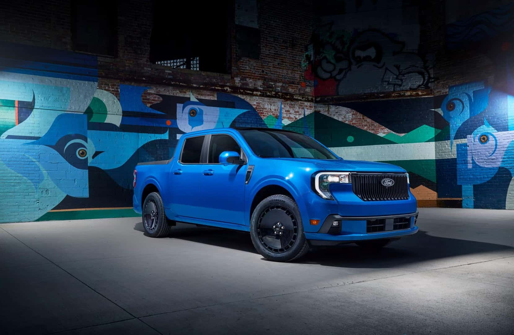 A Beautiful Blue 2025 Ford Maverick Lobo Parked In Front Of A Gorgeous Mural
