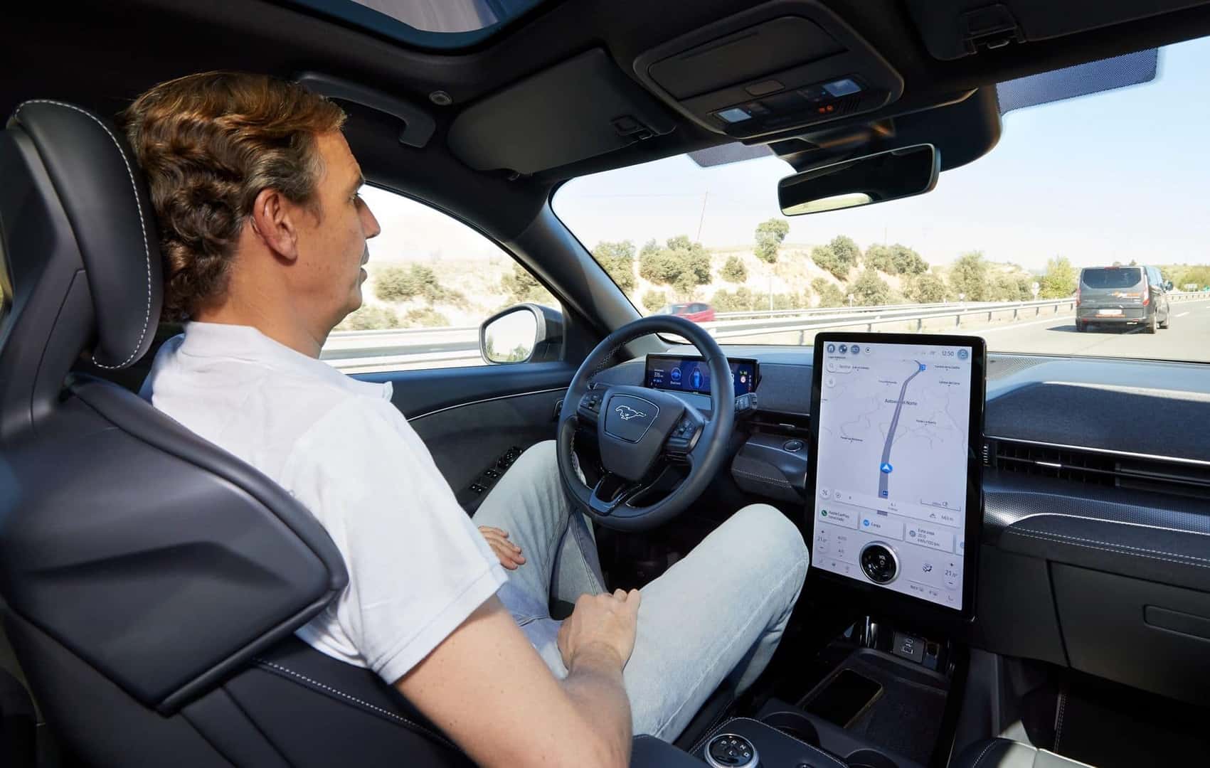 A Bored Adult Man Using BlueCruise On The Highway, Keeping His Hands Close Just In Case