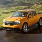2023 Ford Maverick Lariat driving down a wet road in the country