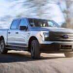 Ford F-150 Lightning driving on a gravel road