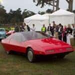 1979 Ford Probe driving by spectators
