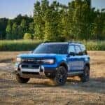 2025 Ford Bronco Sport parked in the dirt in front of the woods
