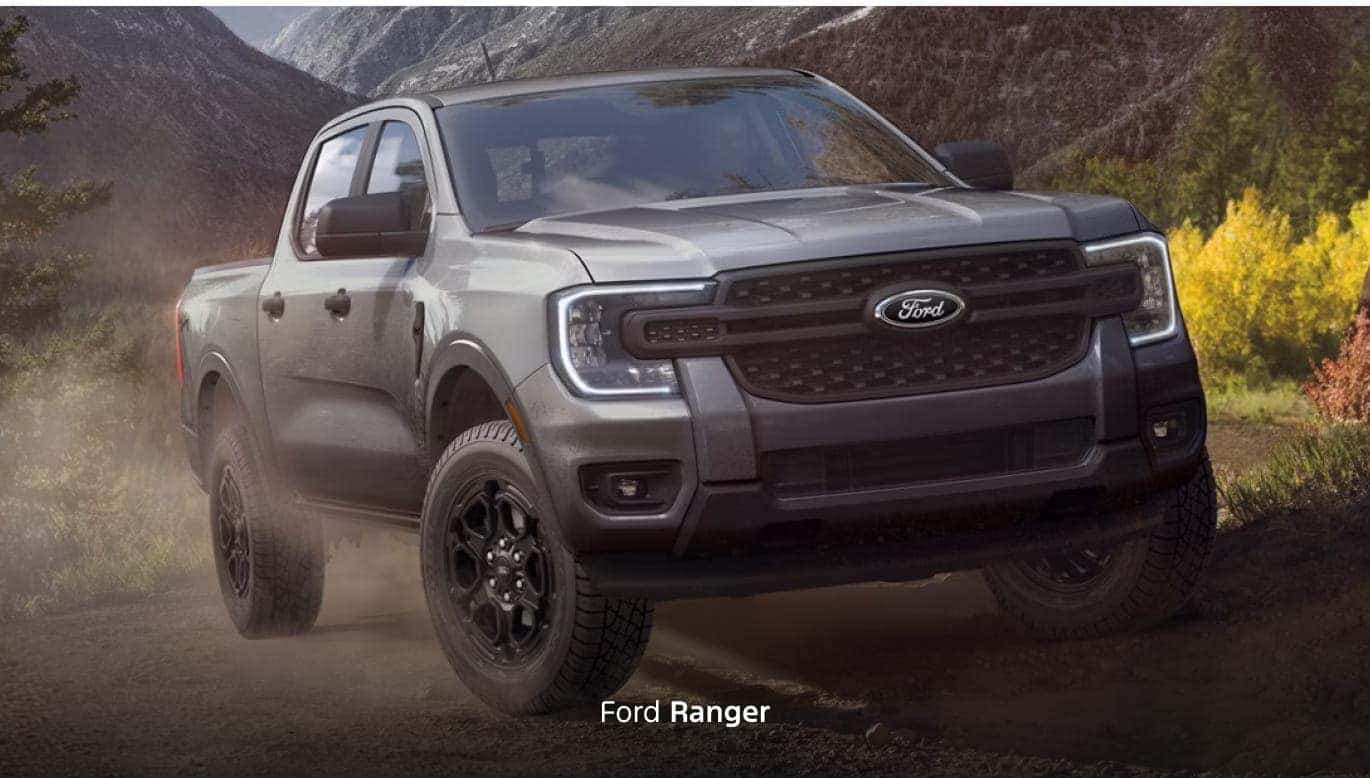 Gray Ford Ranger shown from a front three-quarter angle driving on a rugged mountain trail.