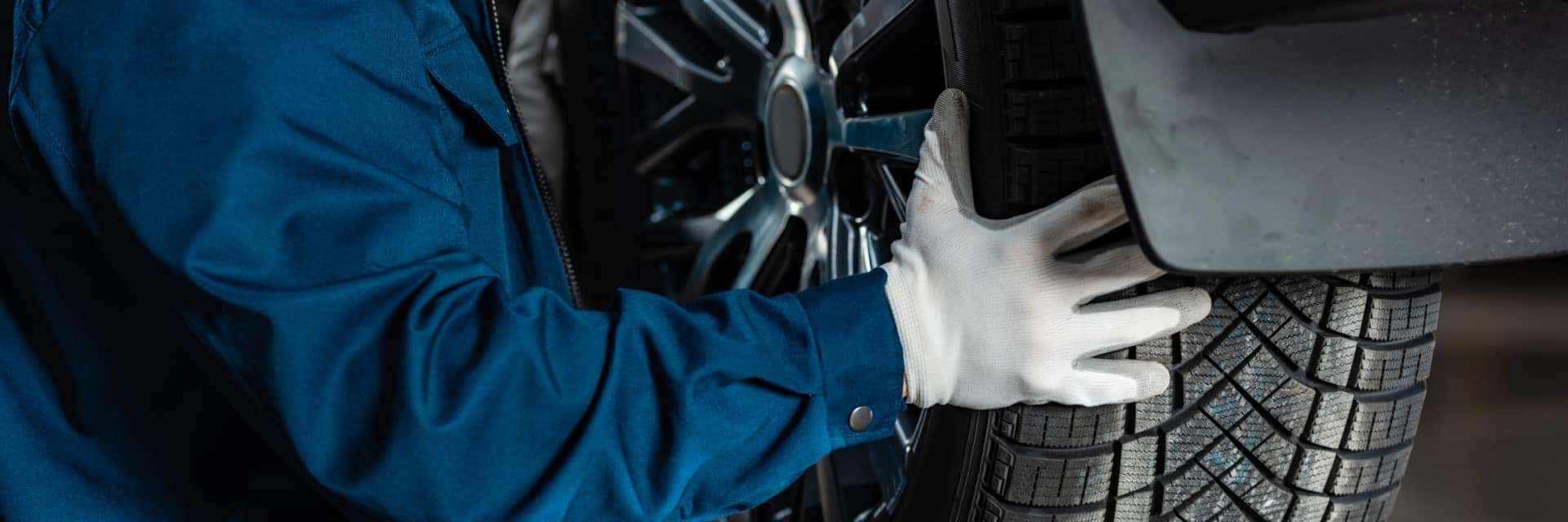 close up of mechanic working on tire