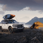 Ford Bronco parked next to tent
