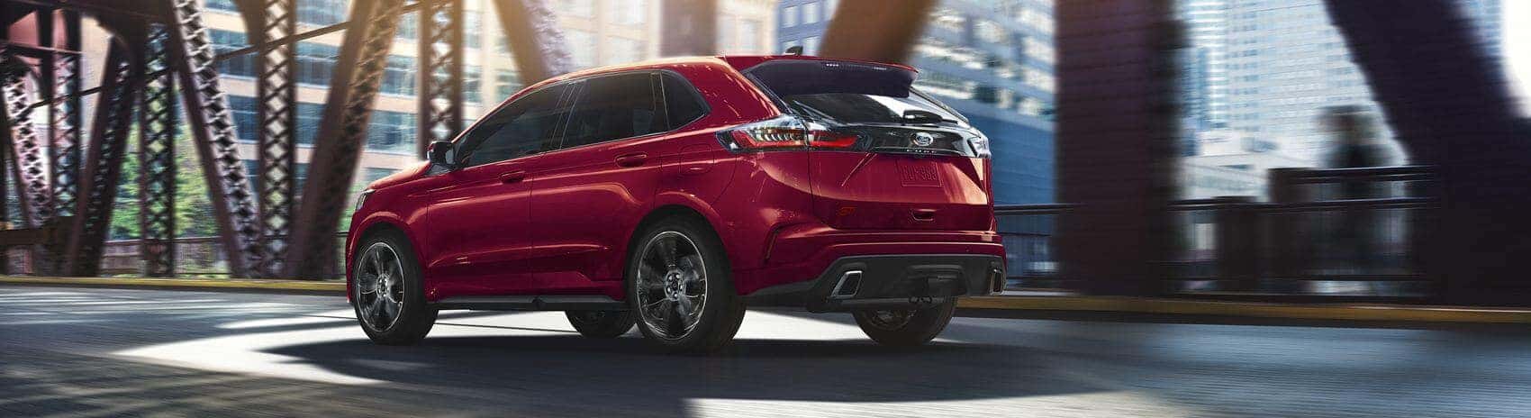 Back view of Ford Edge driving on bridge with motion blur from Ford Dealer near Chino CA