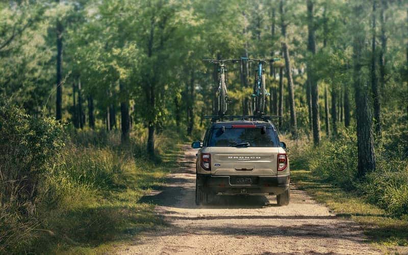 Ford Bronco driving in the woods