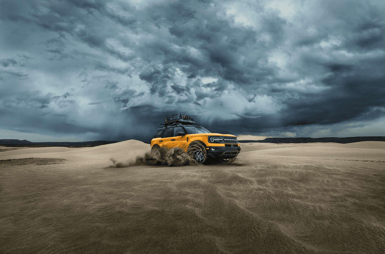 Ford Bronco Sport driving in the desert with cloudy sky in background - Ford Bronco Lease Deals near Upland CA