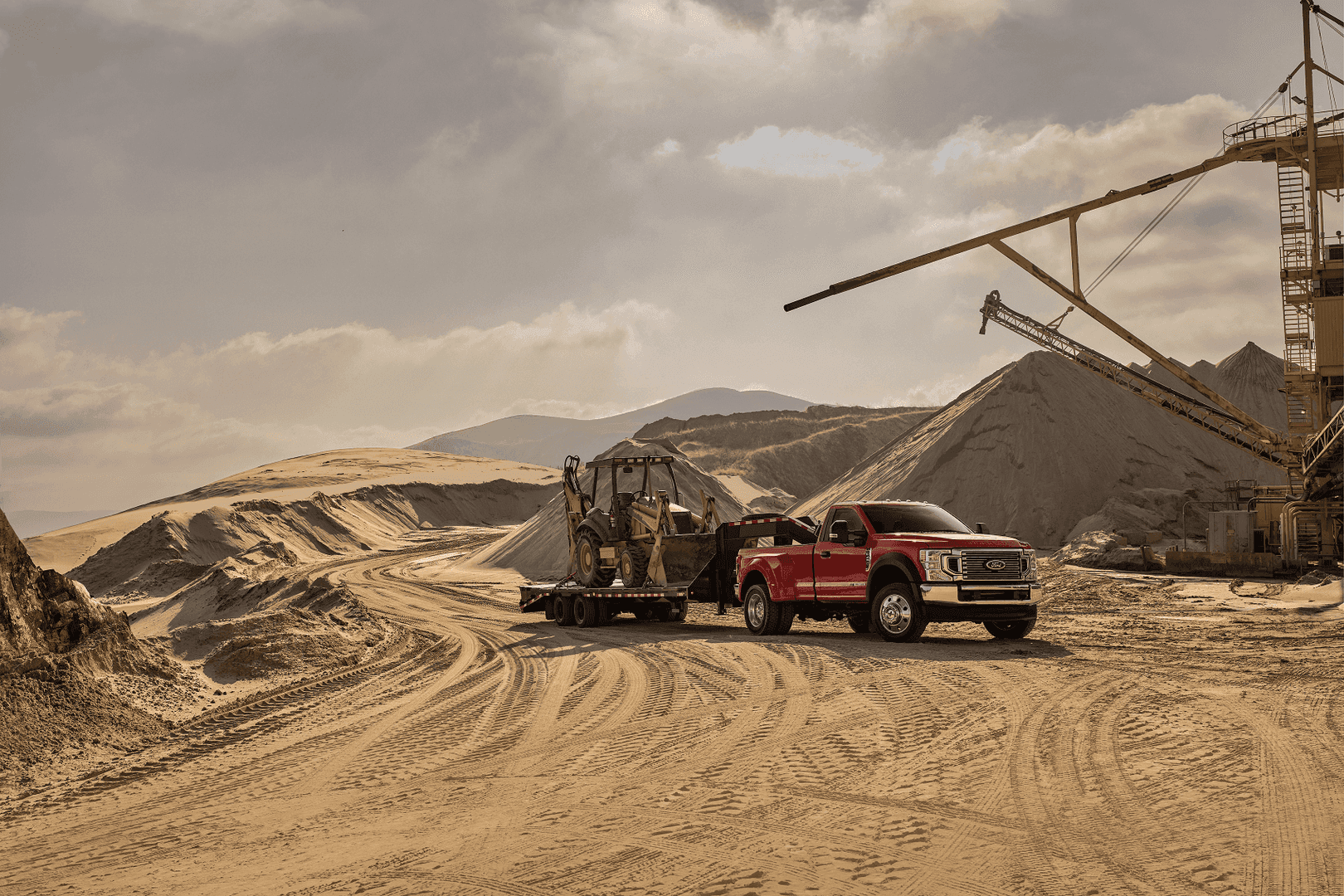 Ford Super Duty truck parked in desert construction site towing machinery from Used Car Dealer in Upland CA