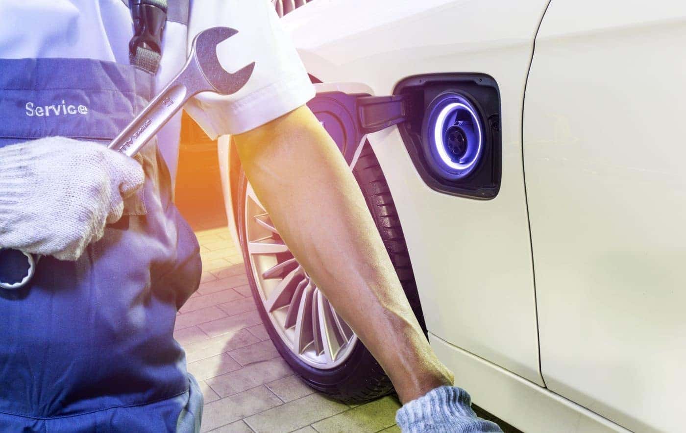 Ford Certified Technician inspecting charging ports on electric vehicle