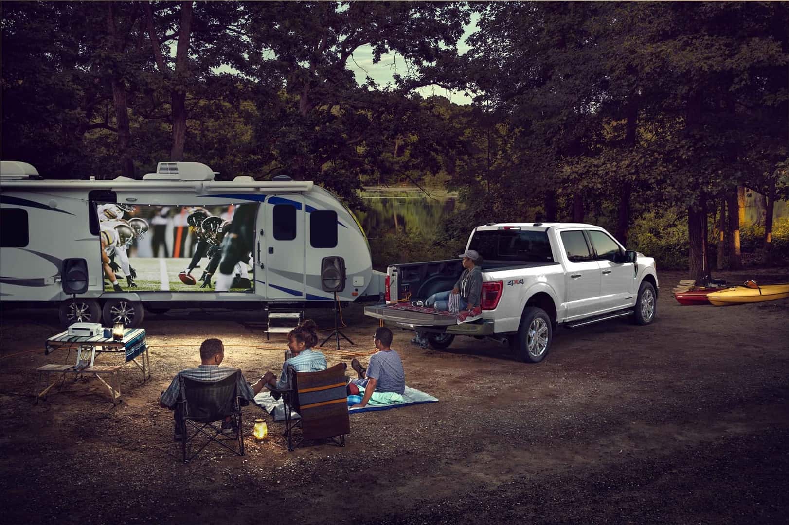 Ford F-150 Truck parked outdoors at campsite where family is relaxing in the evening