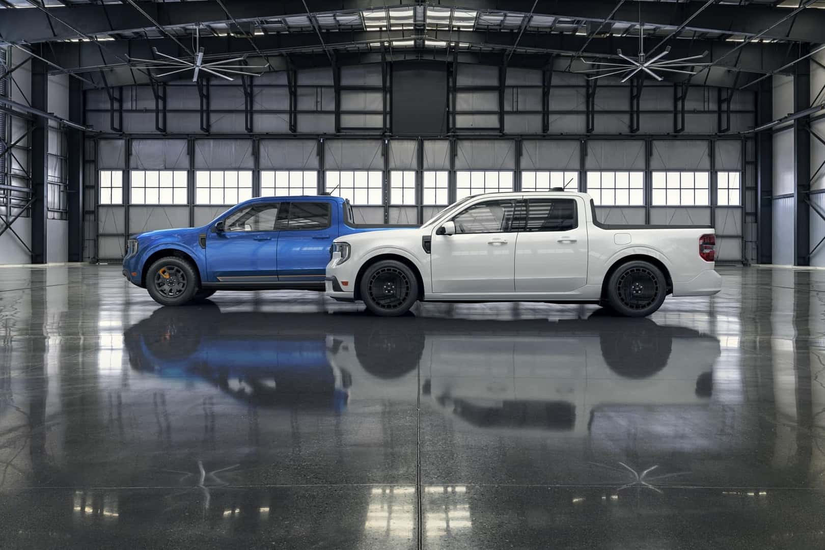 Two Ford Maverick trucks parked in a hanger