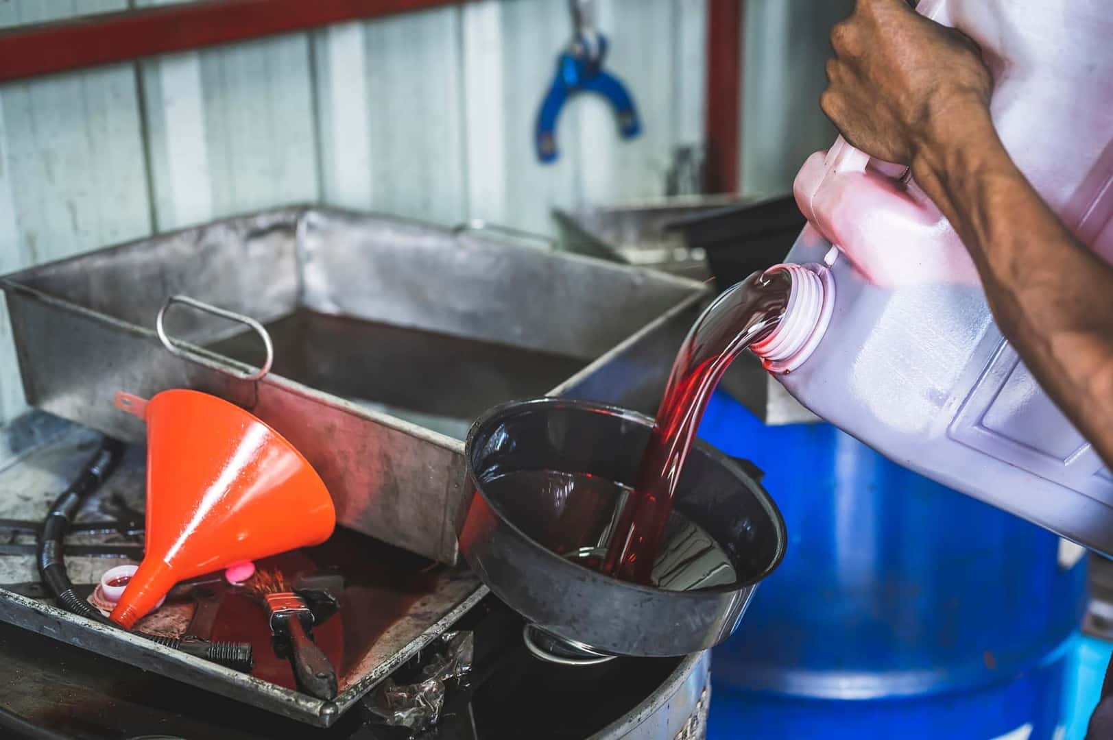 Close up pouring of transmission fluid at Ford Service Center doing Transmission Repair near Upland CA