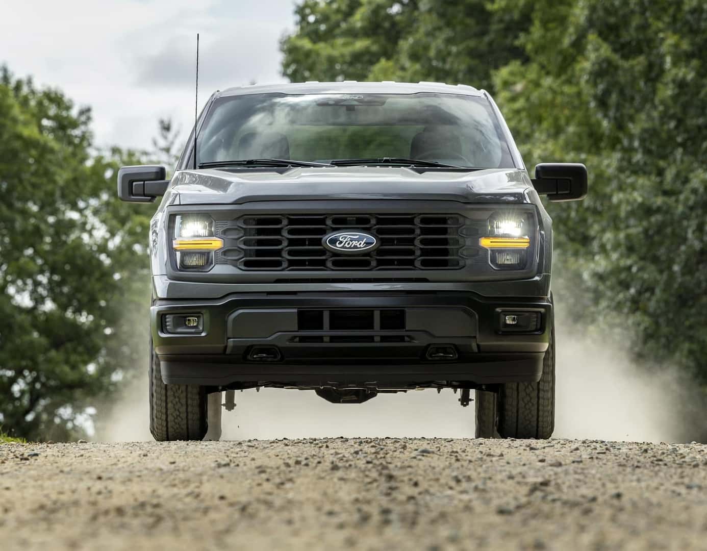 Front View of Ford F-150 driving down dirt road kicking up dirt from Ford F-150 Dealership near Rancho Cucamonga CA
