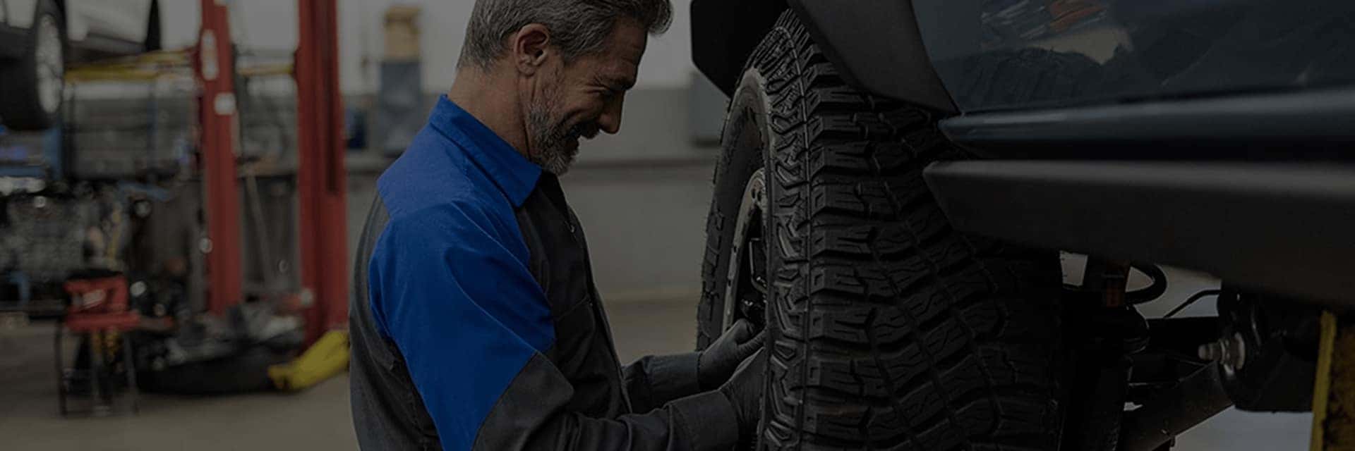 service technician working on tire