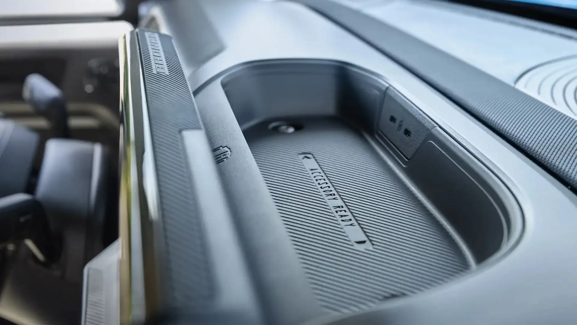 Close-up of 2025 Bronco Sport dashboard tray with "Accessory Ready" mount and USB ports.