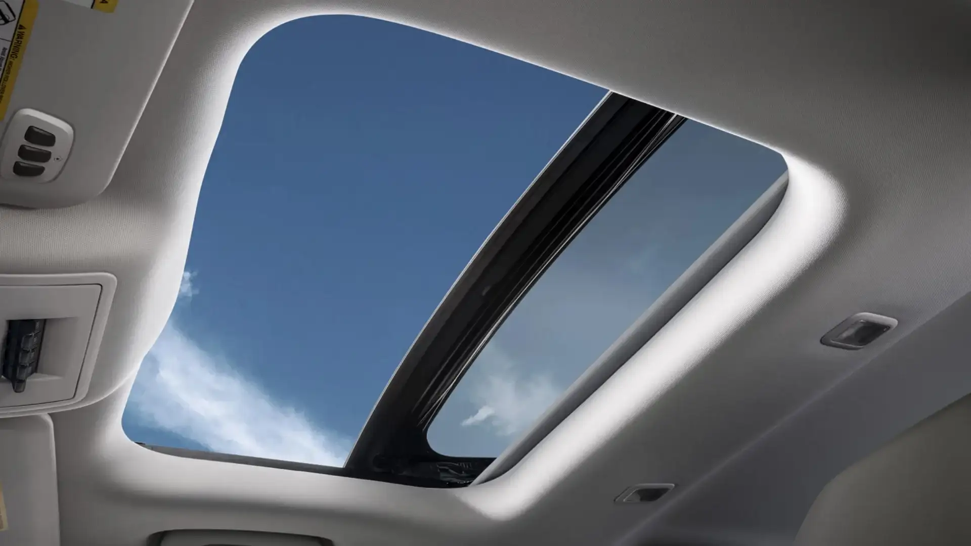 Interior view of 2025 Bronco Sport panoramic moonroof showing sky and headliner details.