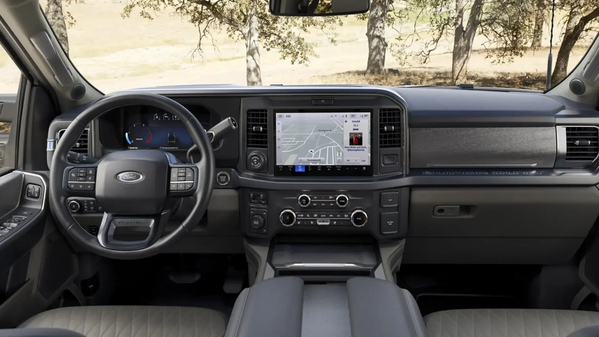 Front interior view of 2026 Ford Super Duty® with SYNC touchscreen, black leather, and digital cluster.