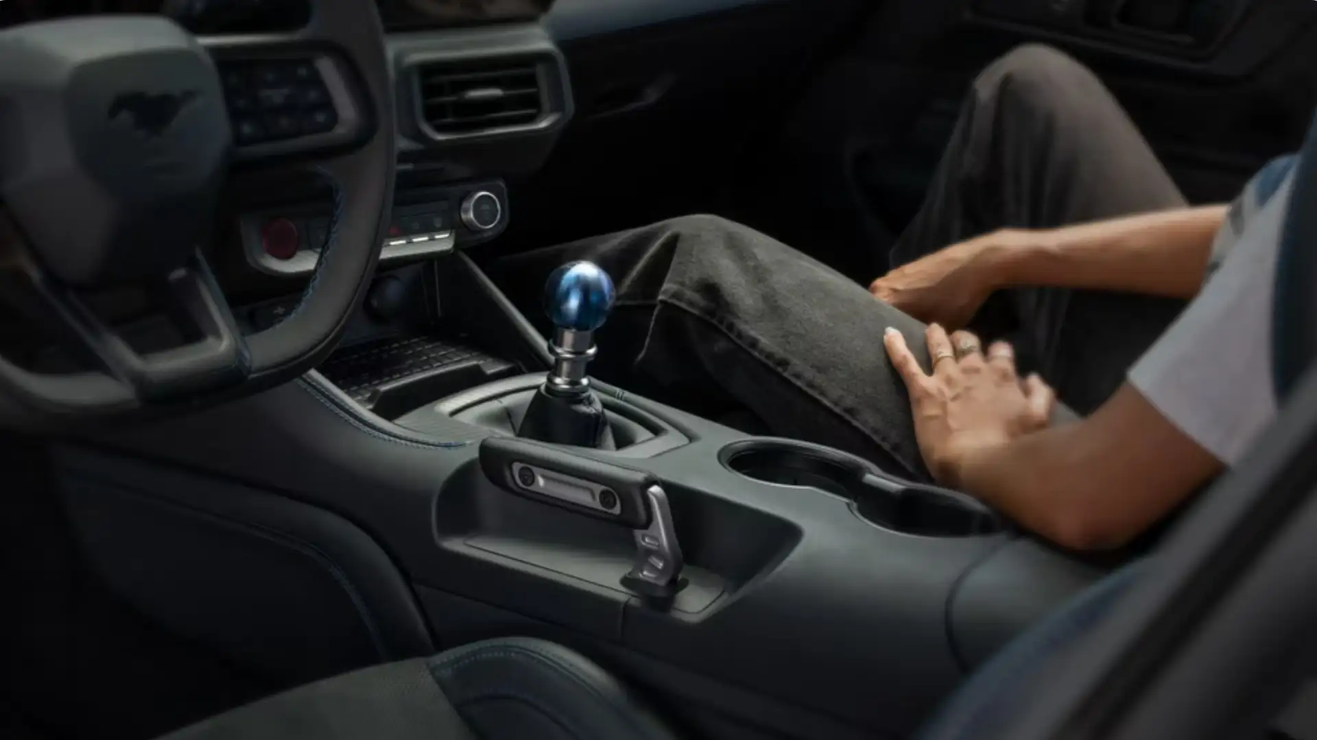 Interior shot of the 2025 Ford Mustang® featuring a manual shifter and driver-focused cockpit layout.