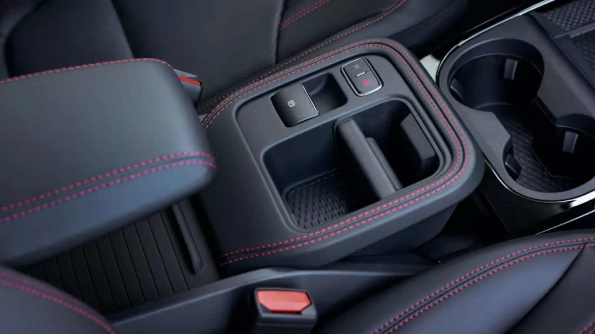 Close-up of the 2025 Ford Mustang Mach-E® center console with red stitching and integrated storage compartments.
