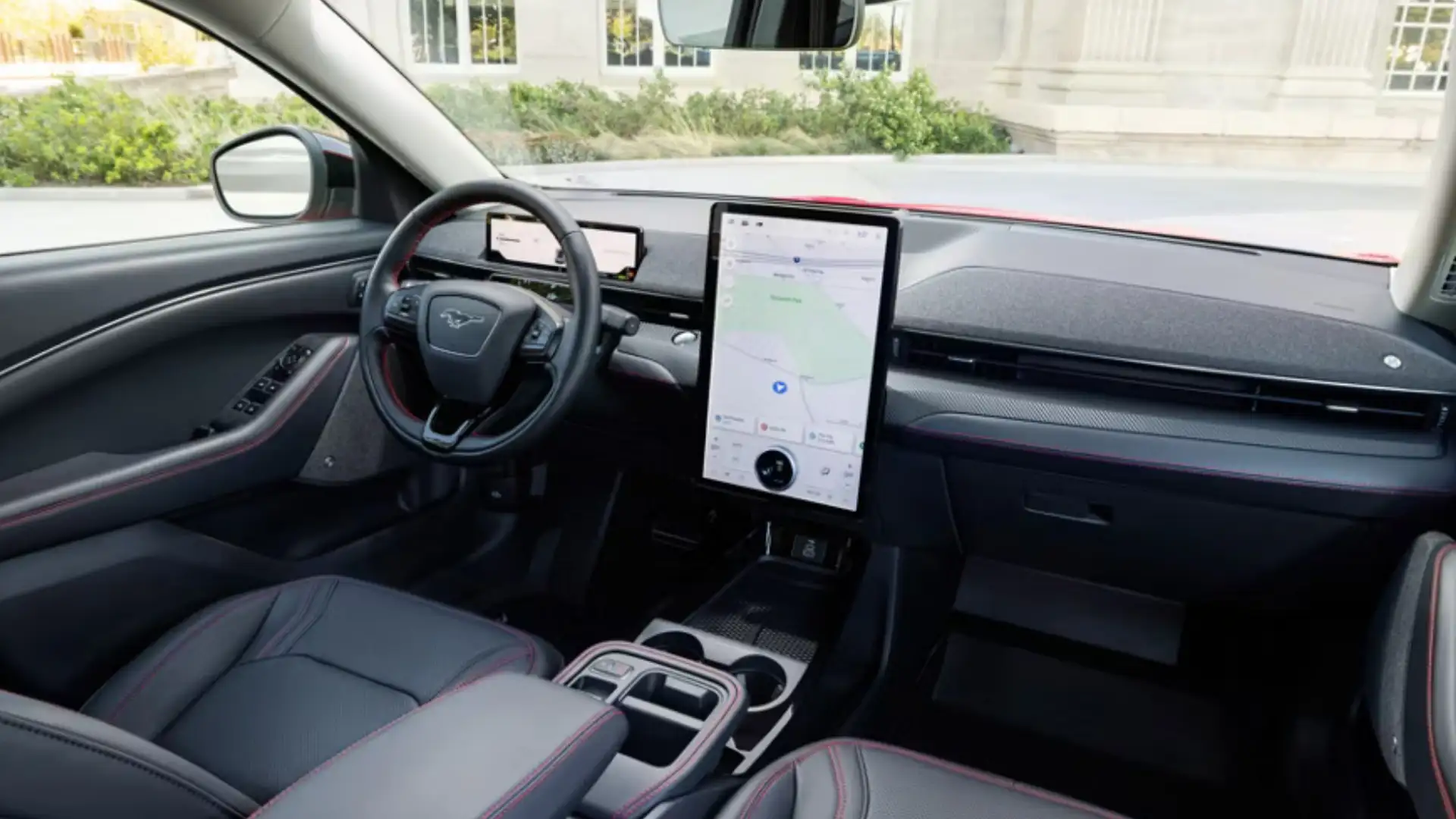 Interior view of the 2025 Ford Mustang Mach-E® featuring a large vertical touchscreen and modern driver-focused cockpit.