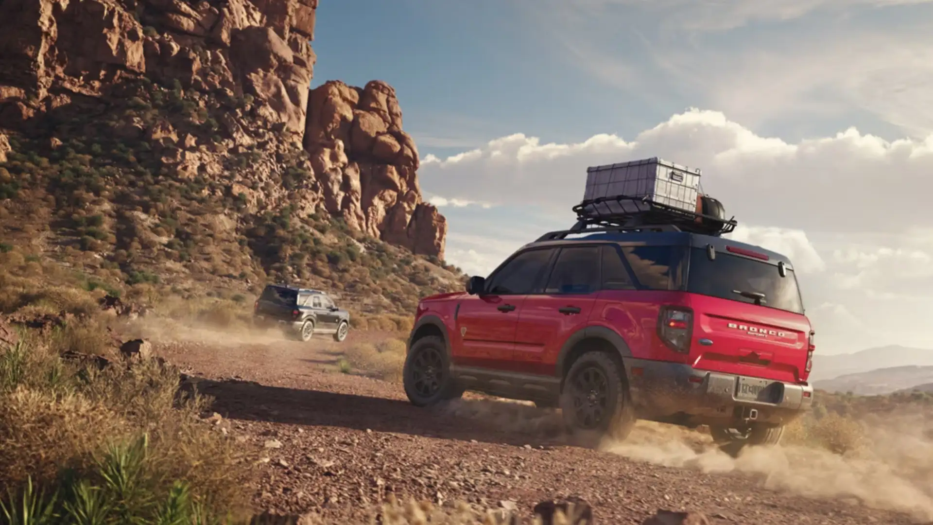 2025 Ford Bronco Sport® rear three-quarter view in red off-roading on rocky desert trail.