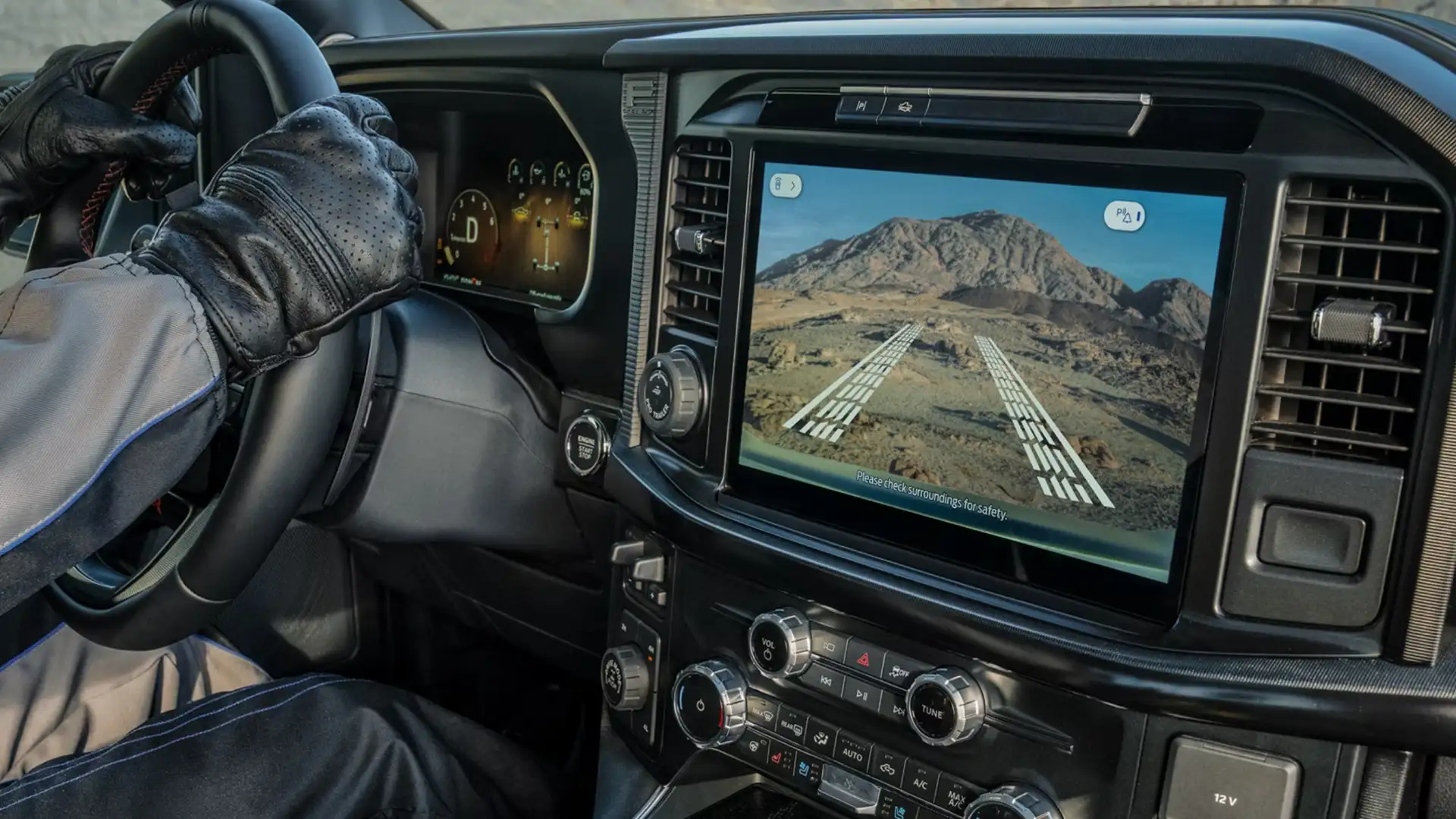 2025 Ford F-150® interior with leather steering wheel, digital dashboard, and Pro Trailer Hitch Assist displayed on the screen.