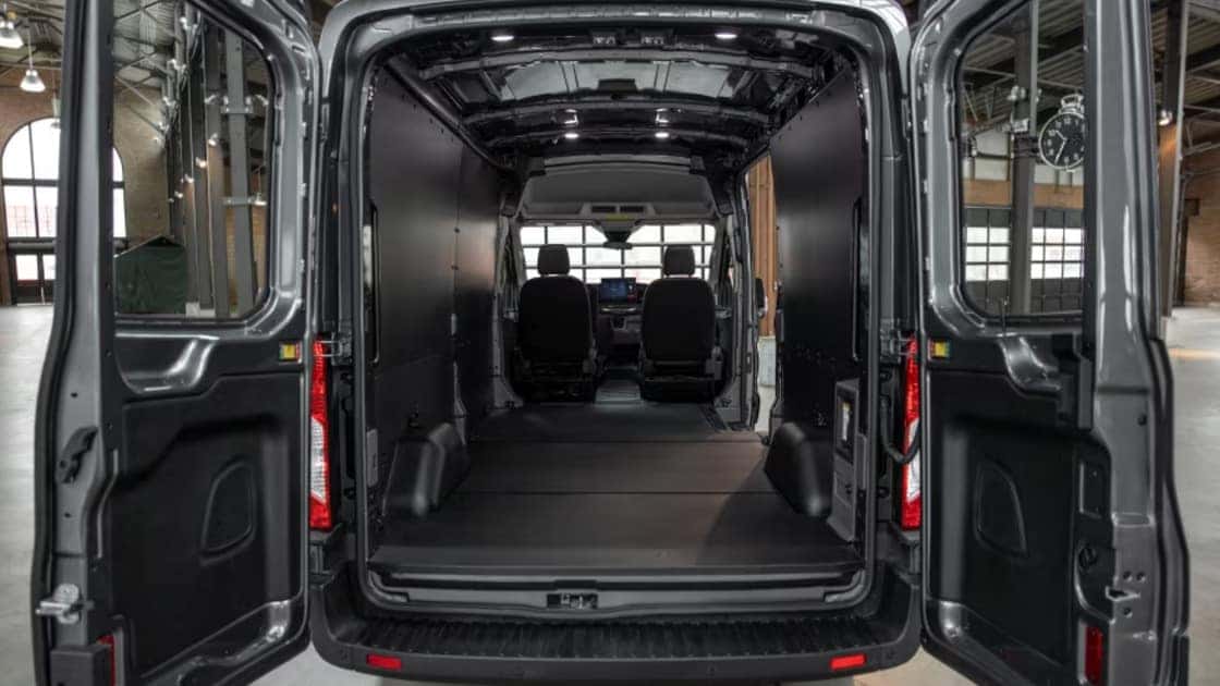 2026 Ford E-Transit™ cargo area with rear doors open showing spacious interior storage.