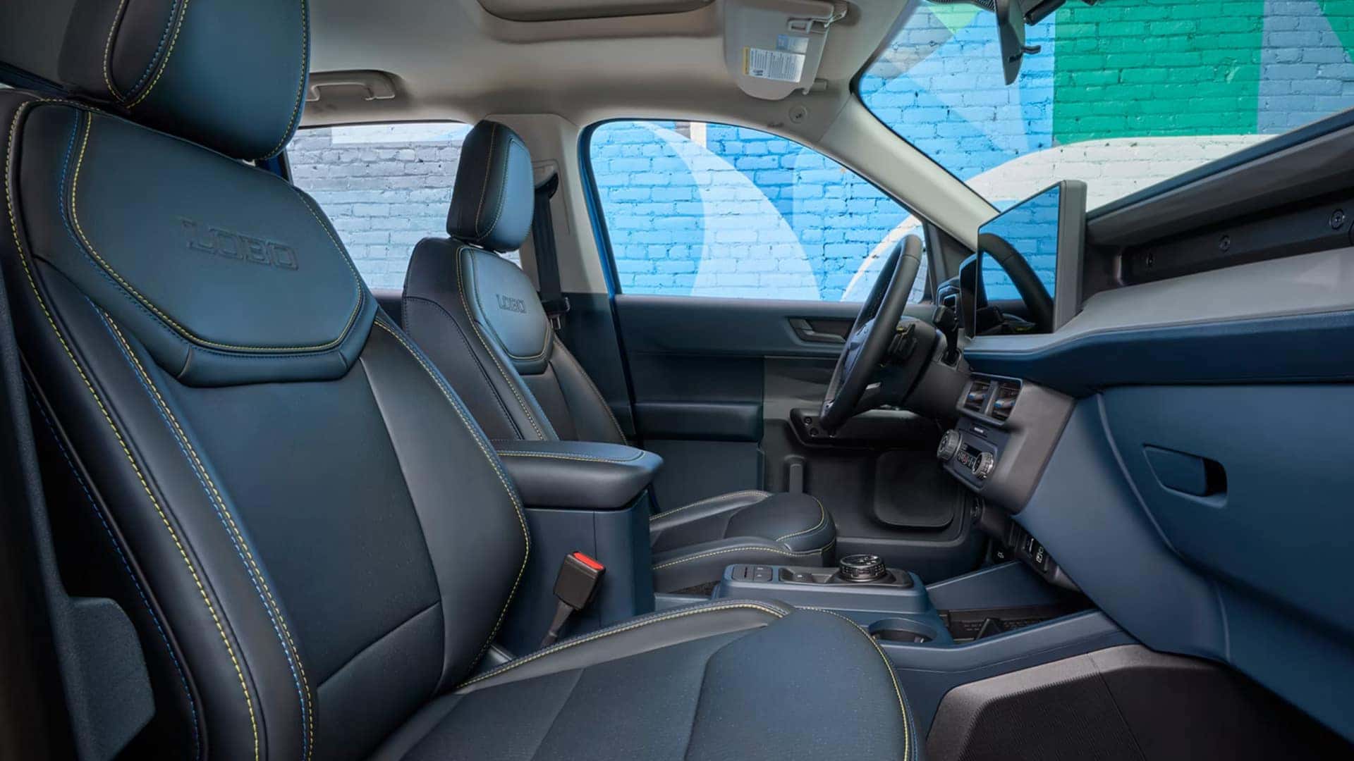 2026 Ford Maverick® interior showing front seats, steering wheel, dashboard, and panoramic sunroof with bright exterior view.