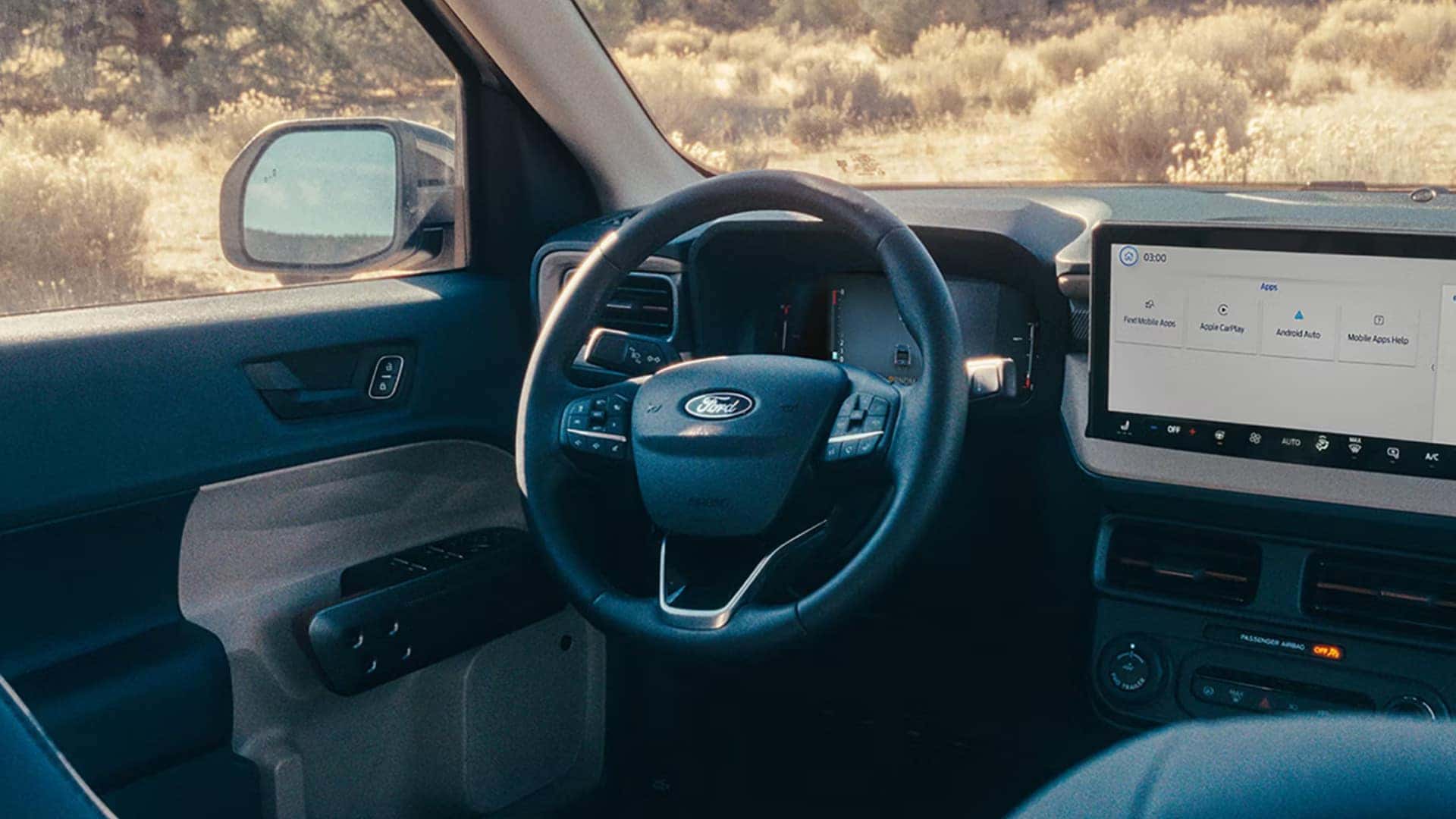 2026 Ford Maverick® interior driver view highlighting steering wheel, touchscreen display, and center console controls.